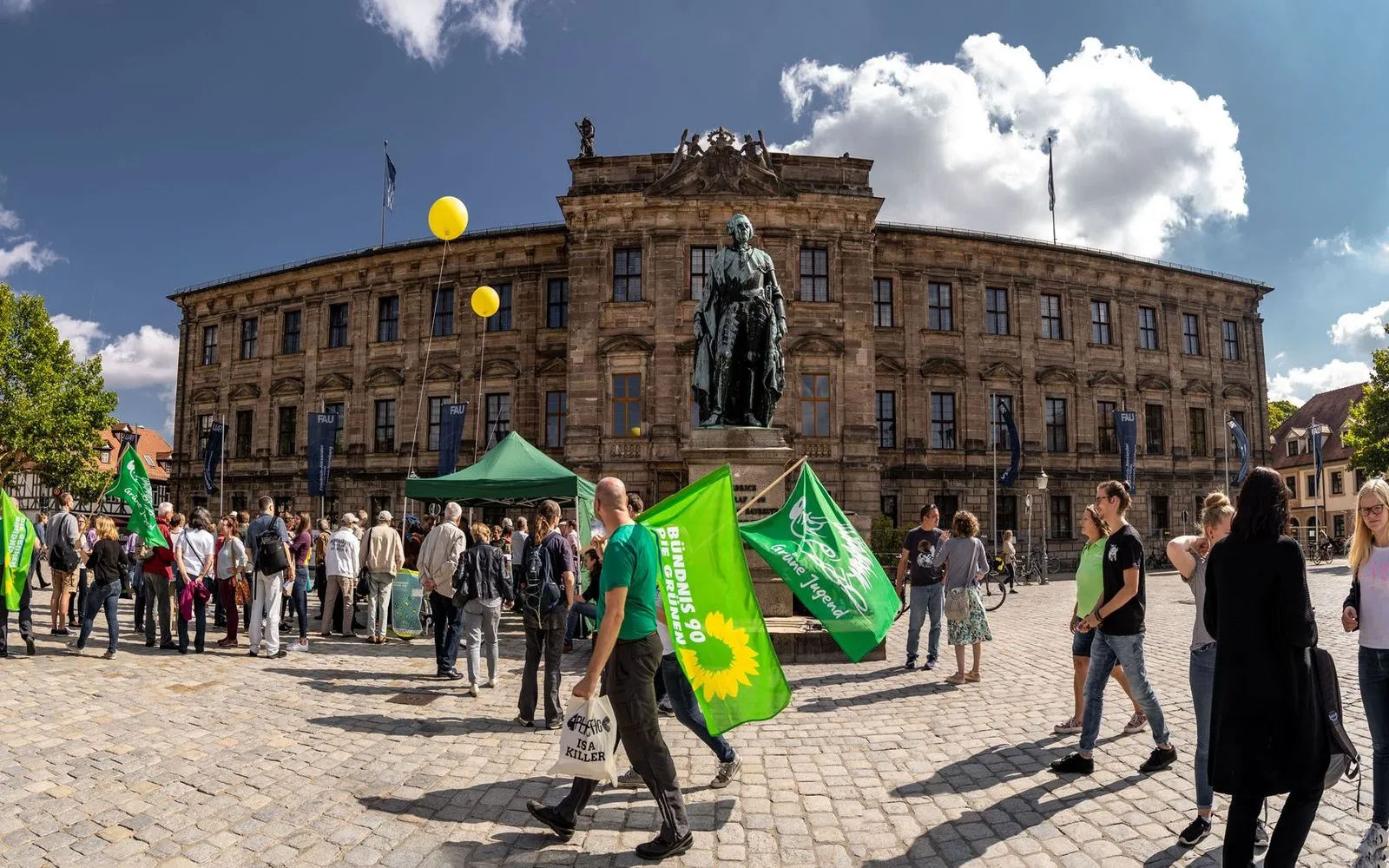 Demonstration at Erlangen University in Germany with flags and crowd.